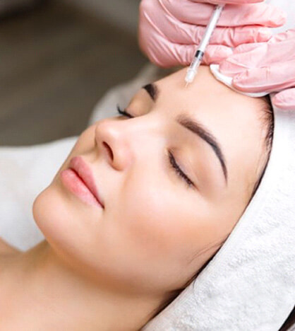 Woman relaxing while receiving BOTOX injection in forehead