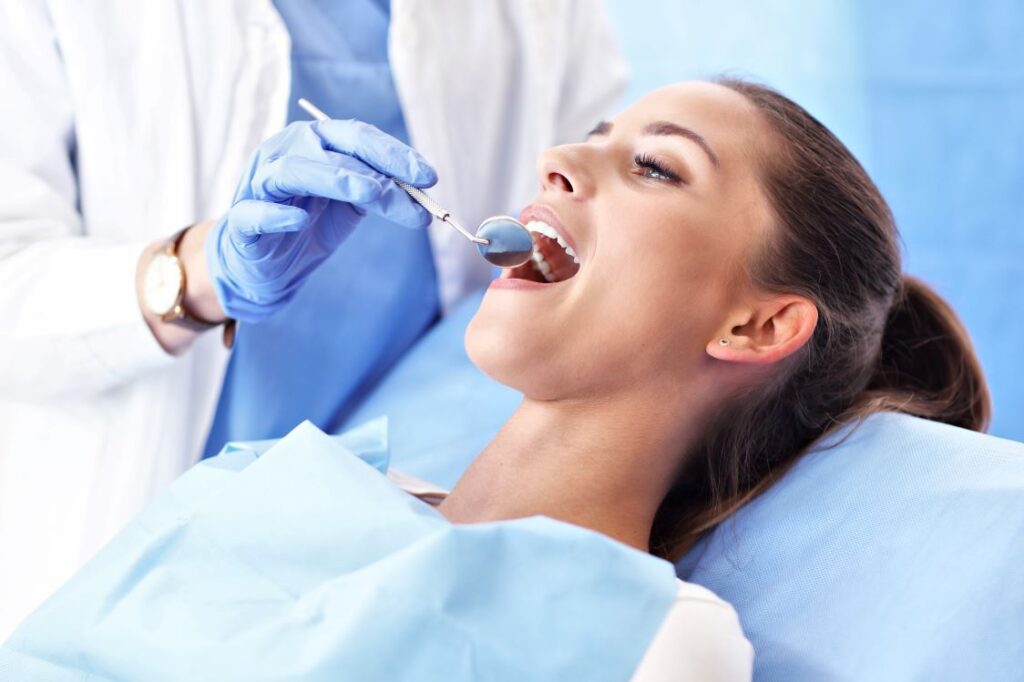 A woman in a dentist's chair getting a root canal.